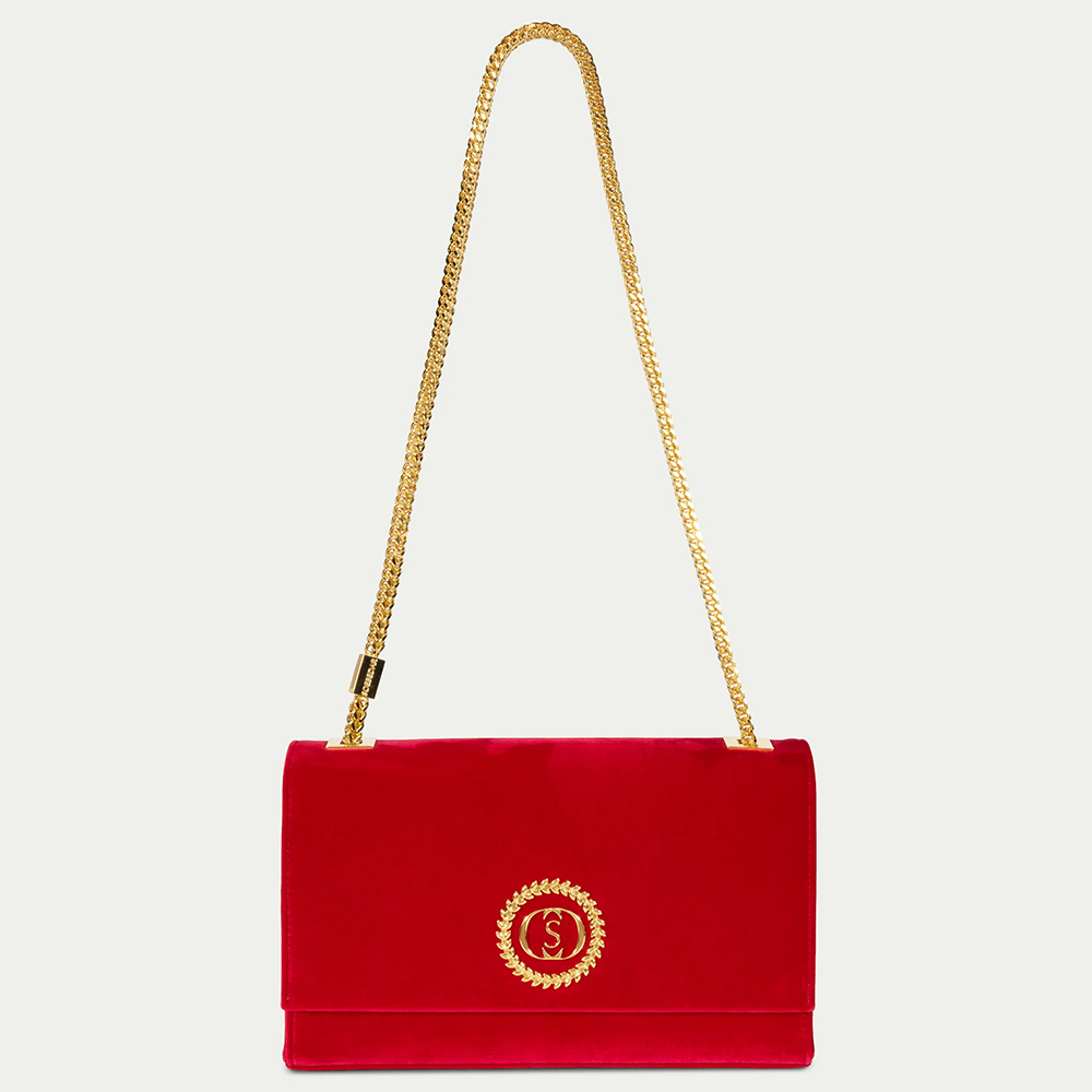 This velvet bag is hand-finished in Italy with gold plated hardware.