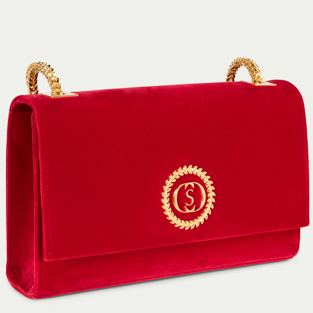 This velvet bag is hand-finished in Italy with gold plated hardware.