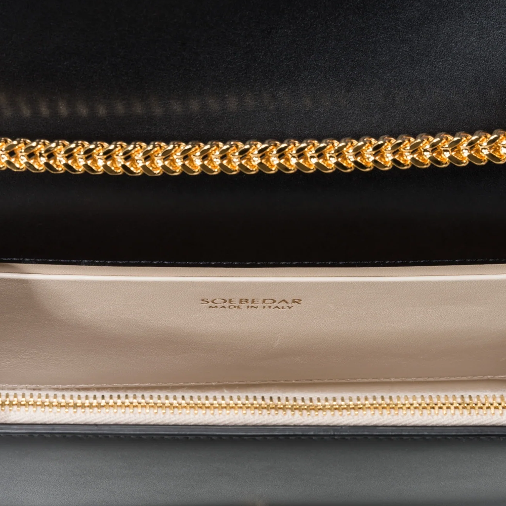 This velvet bag is hand-finished in Italy with gold plated hardware.