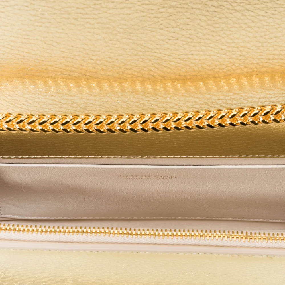 This velvet bag is hand-finished in Italy with gold plated hardware.