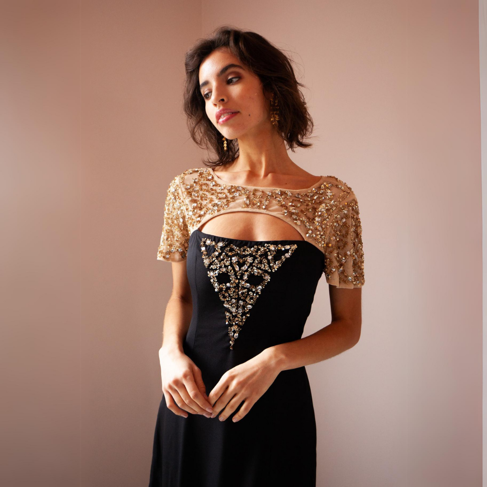 The Zadie Gown features a mesh neckline with a front opening. Sequin and beaded embellishments