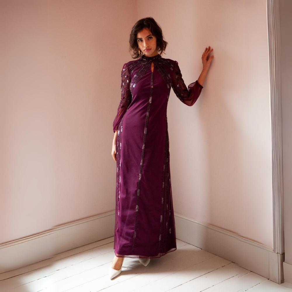 Stunning burgundy-coloured maxi gown with mesh sleeves and beading throughout.