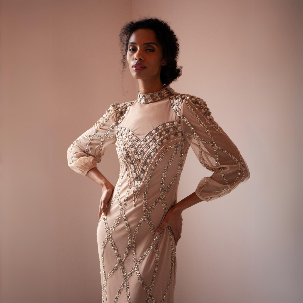 The Fiona Gown is a sophisticated and elegant with its high neck, long mesh sleeves, gold sequins and beads. 