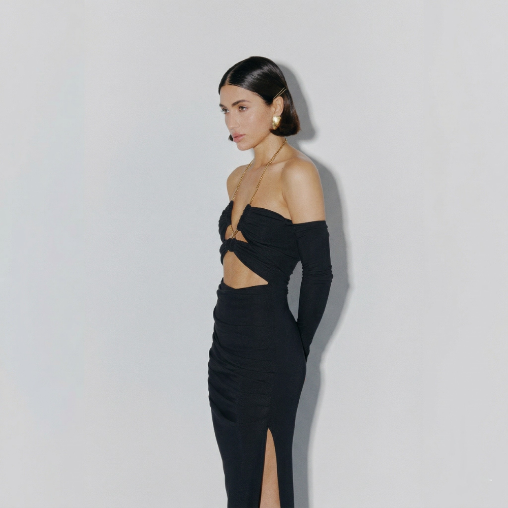 Turn heads in this stunning fitted dress with a chic gold chain and bold leg slit. Perfect for evenings and special occasions. Shop now at our exclusive clothing website.