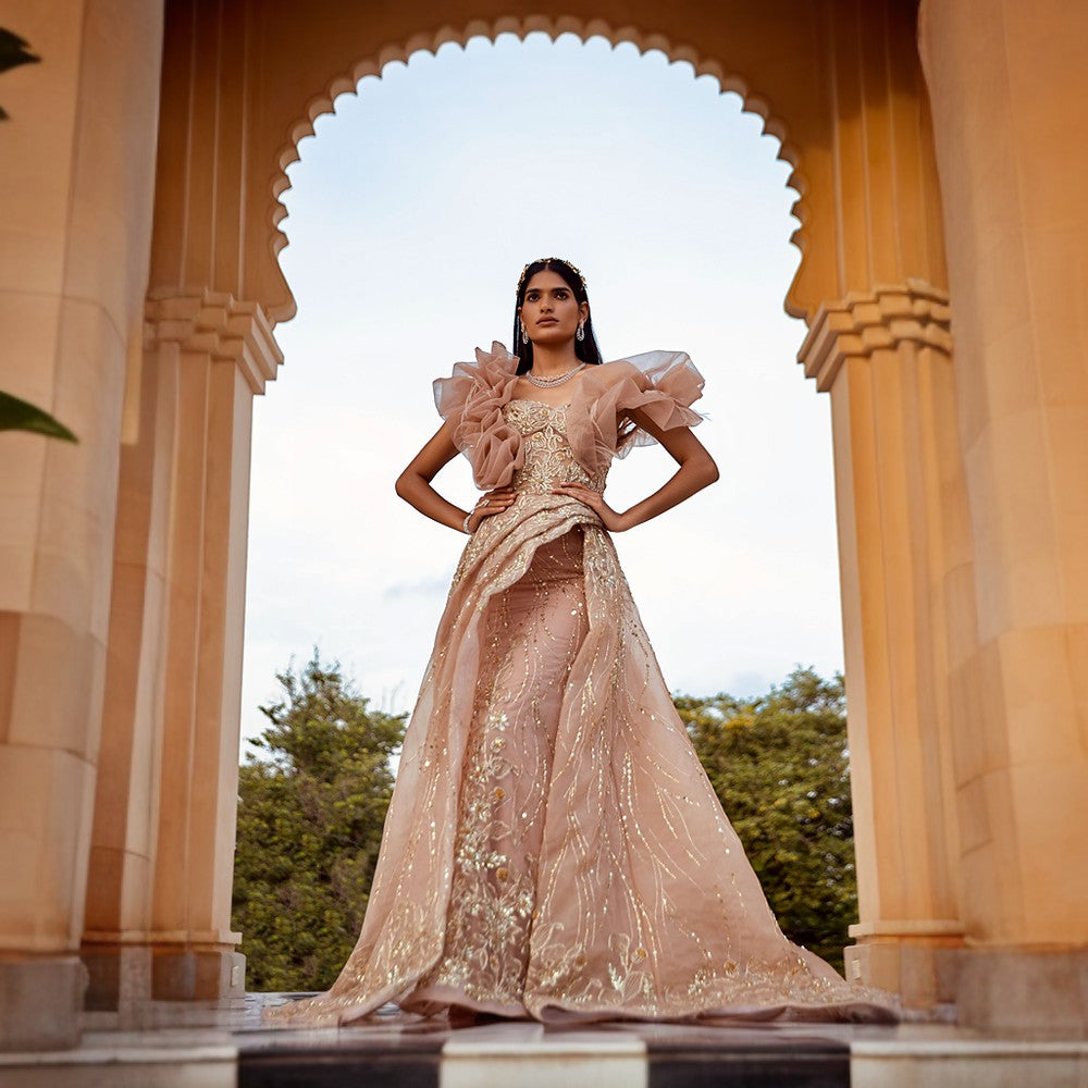 Signature Motifs of waterlilies in Brushstroke embroidery with rossette drape over bodice and wrap bustle over pillar gown.