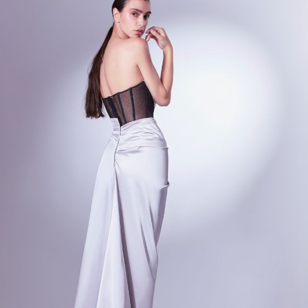 With a rebellious spirit, this dress is tailored in silver satin and draped on a ribbed black tulle corset. 