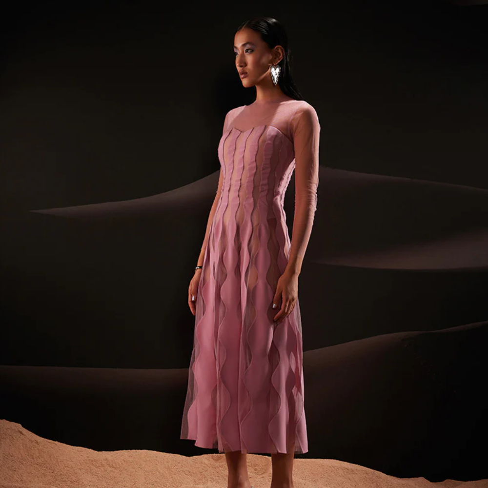 Geometric scallop-shaped patterns in crepe and net are cut and patched together in this flared, ankle-length dress.