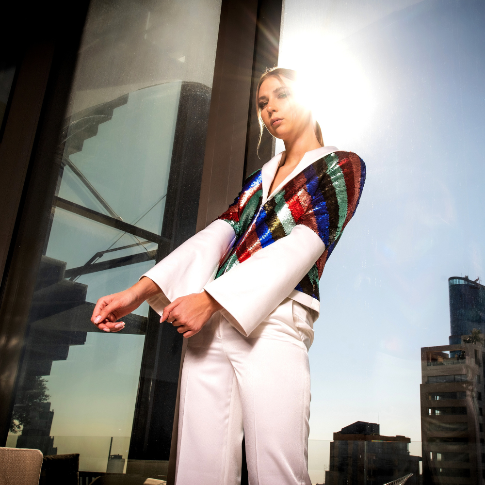 White crepe Blazer in multi-colored sequins and white straight pants.