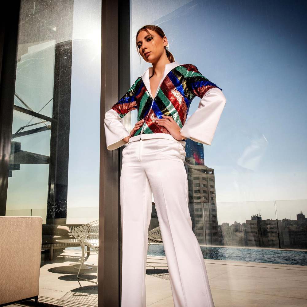 White crepe Blazer in multi-colored sequins and white straight pants.