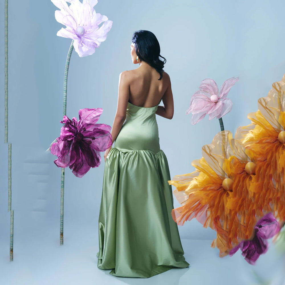 Pastel green strapless gown with fitted bodice and flowy skirt, perfect for events. Shop online from our curated edit of premium fashion.