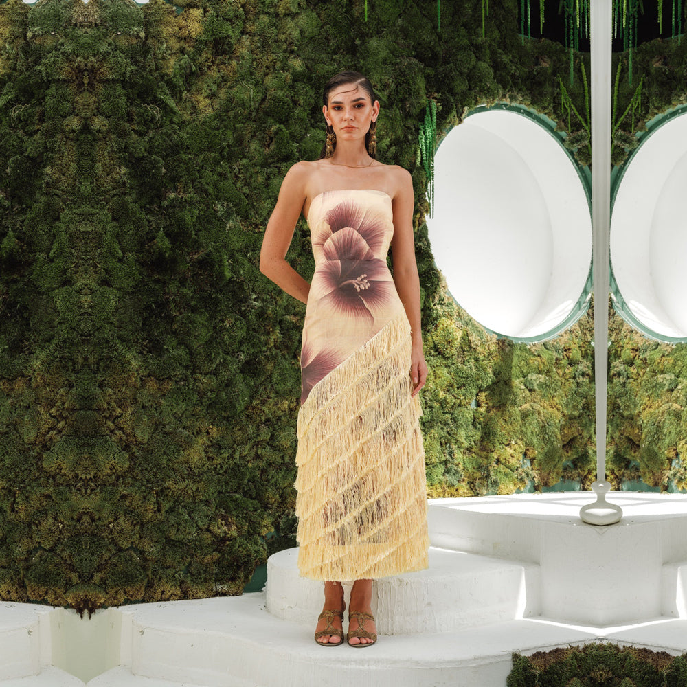 Shop online from our exclusive website and discover the Serena Dress by Nana Gotti, a strapless linen midi dress with a bold floral print, structured bodice, and cascading fringe details.