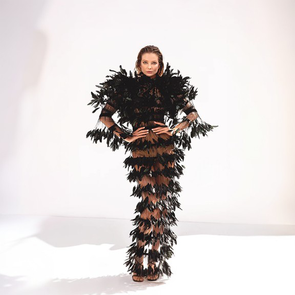 A sheer dress in black tulle and ruffled coq plumes.