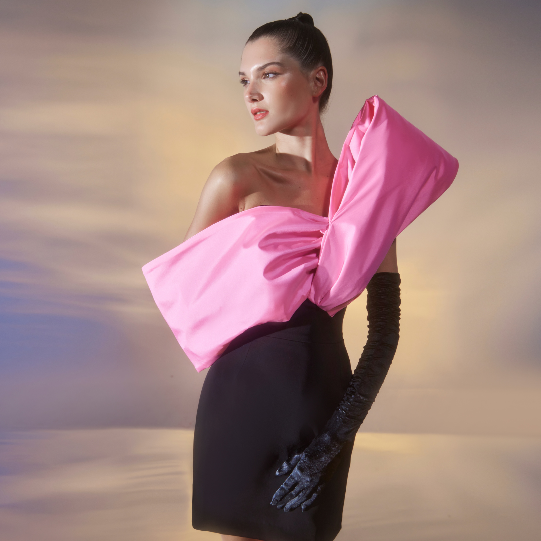 Short Black Cady dress with an exquisite asymmetrical Barbie Pink taffeta twist detail on the neckline.