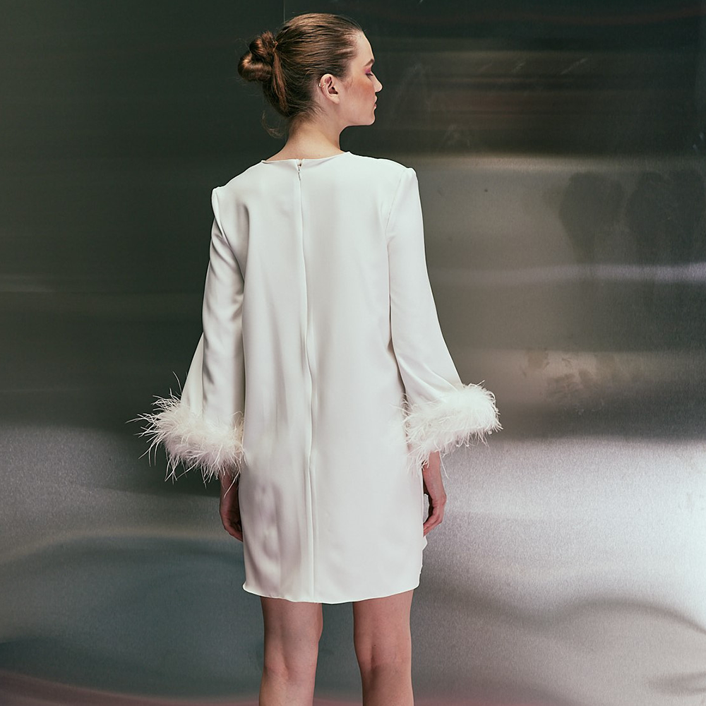 Short long sleeves dress featuring feather. Zip fly at the back of the dress.