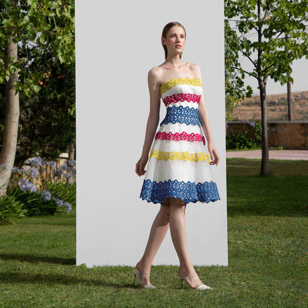 Strapless semi full skirt dress designed with multicolor guipure straps on a striped crain.
