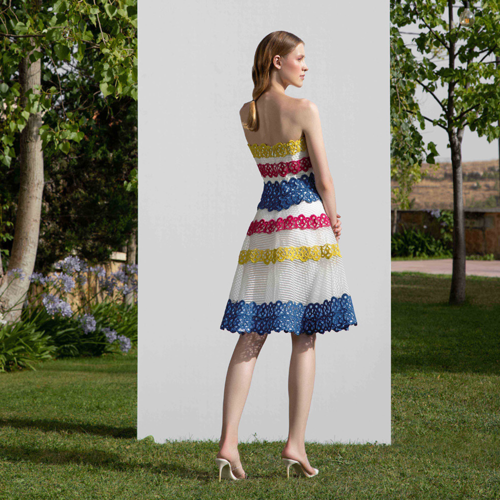 Strapless semi full skirt dress designed with multicolor guipure straps on a striped crain.