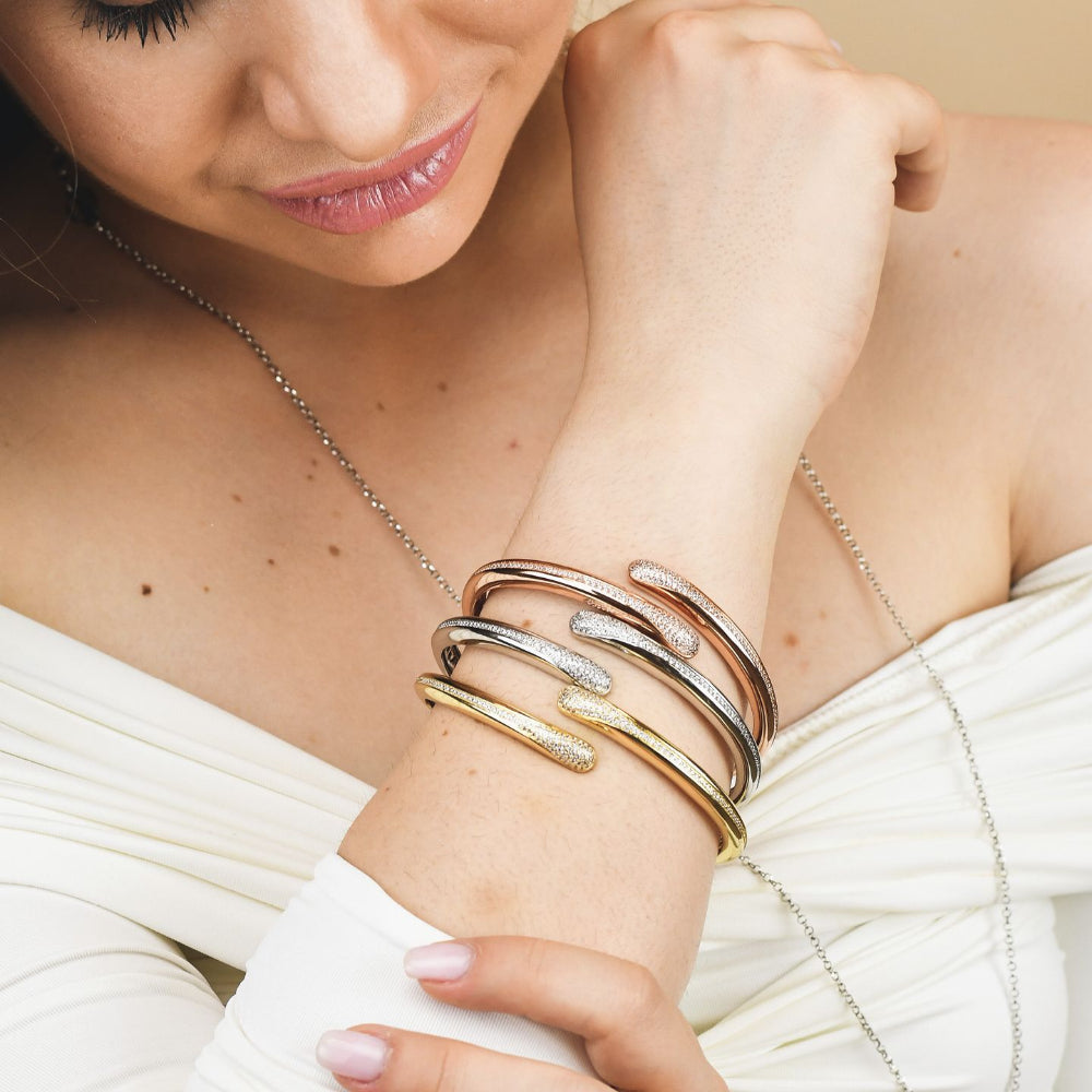 Elegant gold plated bronze wrap cuff bracelet adorned with sparkling pavé cubic zirconia stones for a timeless luxe look. Shop premium jewelry online.