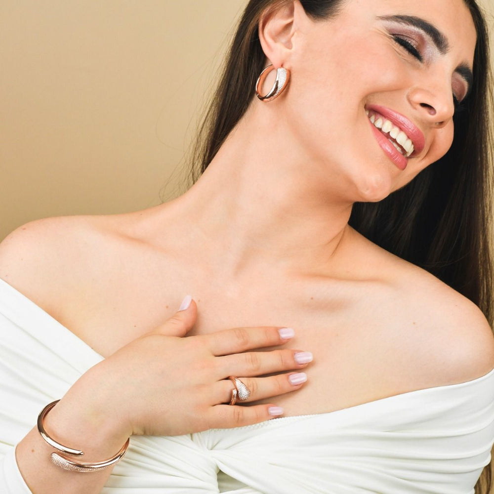 Elegant rose gold plated wrap cuff bracelet adorned with sparkling pavé cubic zirconia stones for a chic luxe statement. Shop premium jewelry online.