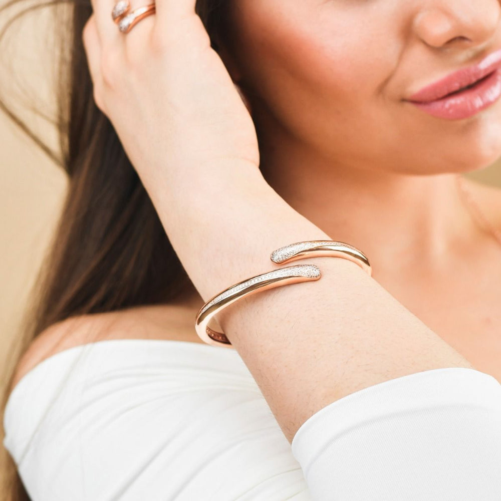Elegant rose gold plated wrap cuff bracelet adorned with sparkling pavé cubic zirconia stones for a chic luxe statement. Shop premium jewelry online.
