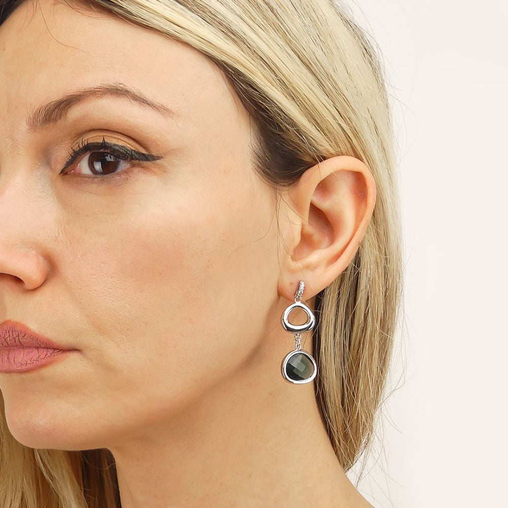 Shop online premium rhodium plated dangler earrings with Montana blue briolette crystal, cubic zirconia detailing and irregular modern design.