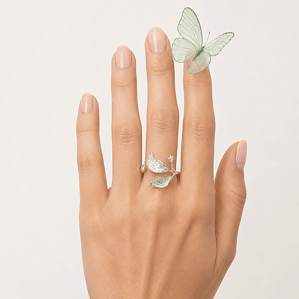 Discover the Silver Wind Leaf Sterling Silver Ring at The Luxe Maison, featuring delicately sculpted leaves and a tiny bud in a nature-inspired design. Crafted in textured S925 sterling silver with an adjustable open band, this elegant ring captures the beauty of leaves in motion and adds an organic, graceful touch to everyday style.