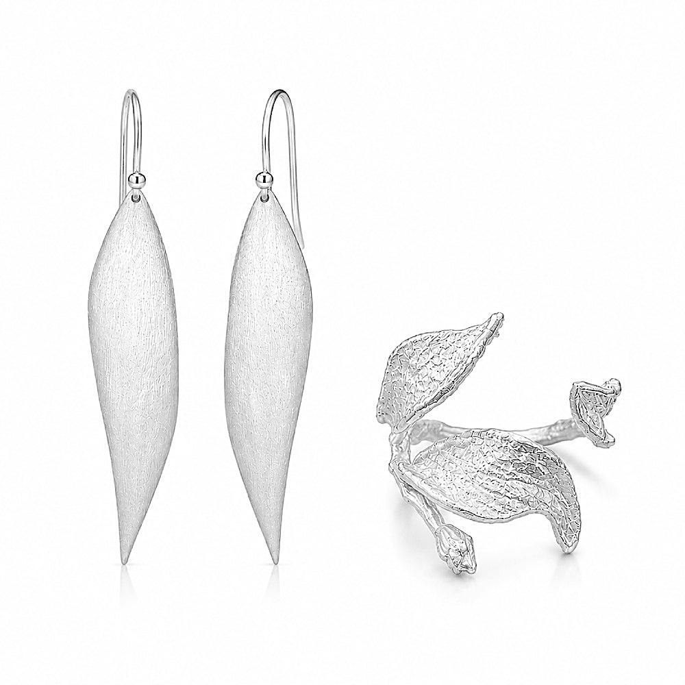Discover the Silver Wind Leaf Sterling Silver Ring & Earrings Jewelry Set at The Luxe Maison, featuring nature-inspired leaf designs, an adjustable silver ring, and elegant elongated earrings for a graceful, timeless look.