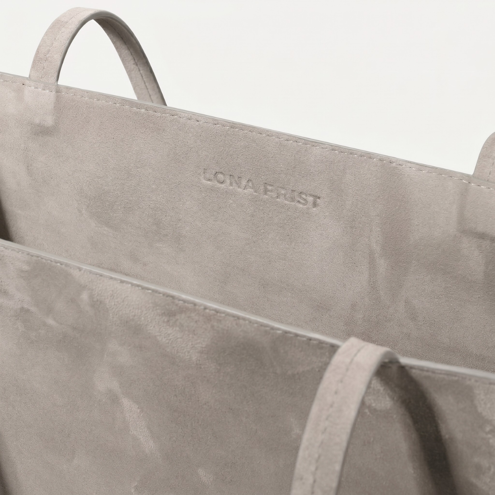 Compact suede tote bag with soft lining, ideal for daily essentials. Shop online from our curated edit of premium fashion.