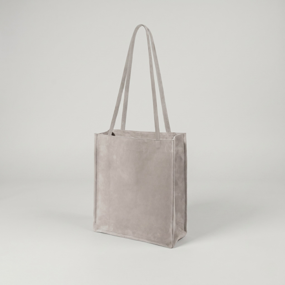 Compact suede tote bag with soft lining, ideal for daily essentials. Shop online from our curated edit of premium fashion.