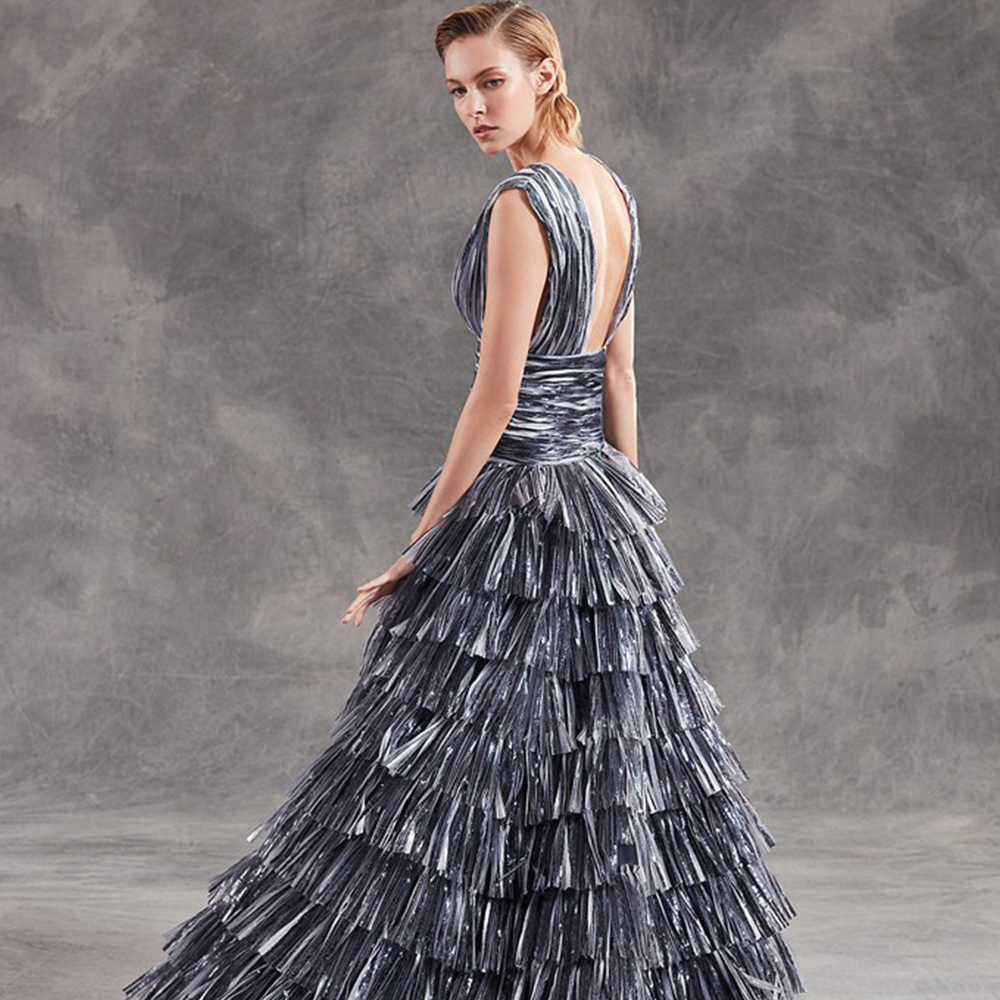 Ballgown in pleated laminated illusion tulle with deep v neckline.