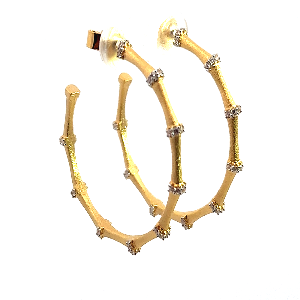 Shop sterling silver bamboo hoop earrings featuring sparkling cubic zirconia. Timeless, elegant hoops crafted for everyday wear and special occasions.