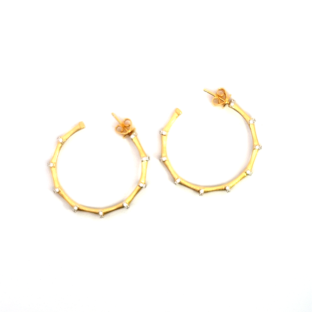 Shop sterling silver bamboo hoop earrings featuring sparkling cubic zirconia. Timeless, elegant hoops crafted for everyday wear and special occasions.