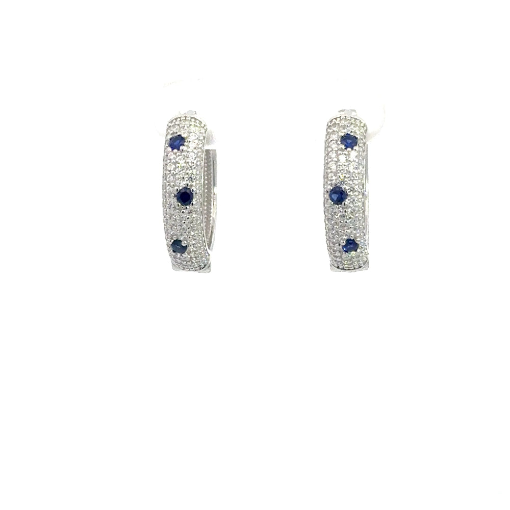 Shop sterling silver blue sapphire huggie earrings featuring lab-created blue sapphire, sparkling cubic zirconia, and an elegant oval pavé design.