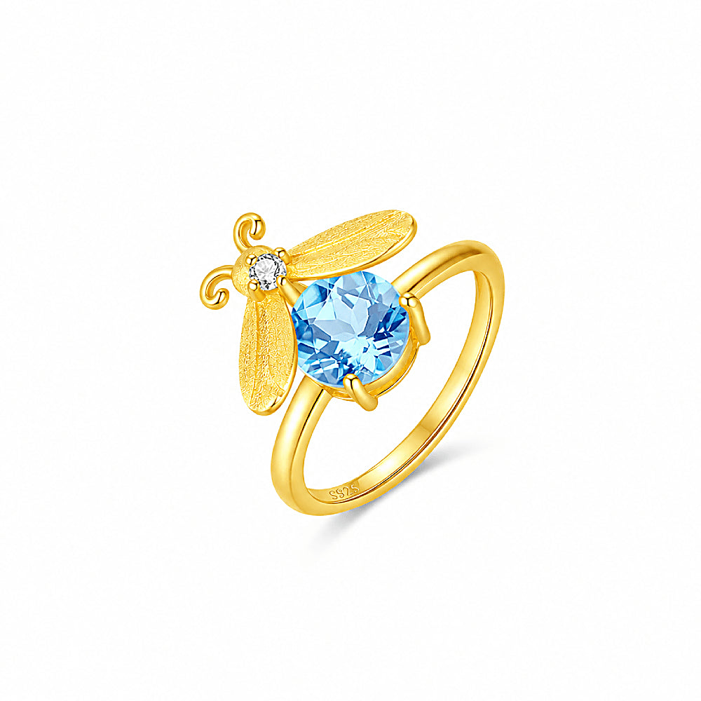 Discover the Summer Firefly Blue Topaz Gold Vermeil Ring at The Luxe Maison, featuring a natural blue topaz centerpiece set in luxurious 18K gold vermeil over sterling silver. Inspired by the enchanting glow of summer fireflies, this elegant ring adds a touch of luminous color and timeless sophistication to everyday wear and special occasions.