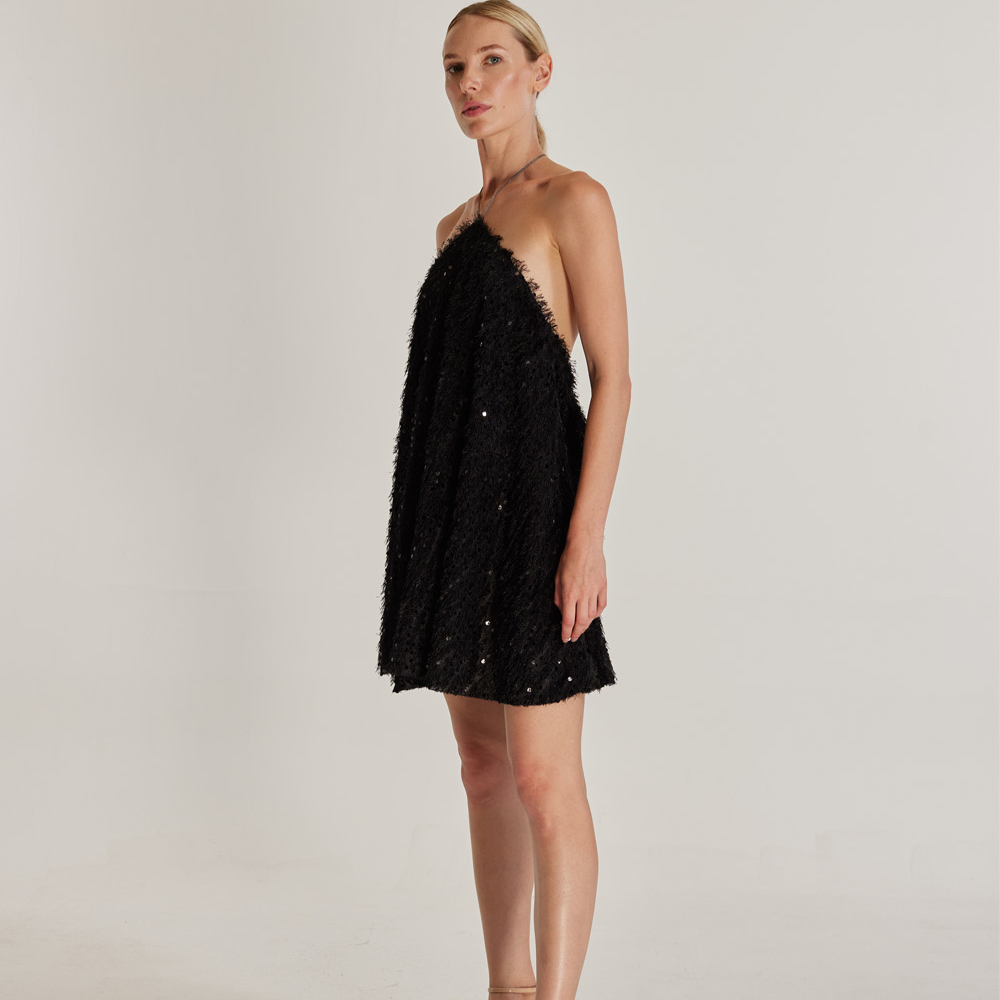 The Sunbeam Dress is a captivating mini dress made from sequined and tasseled black fabric. 