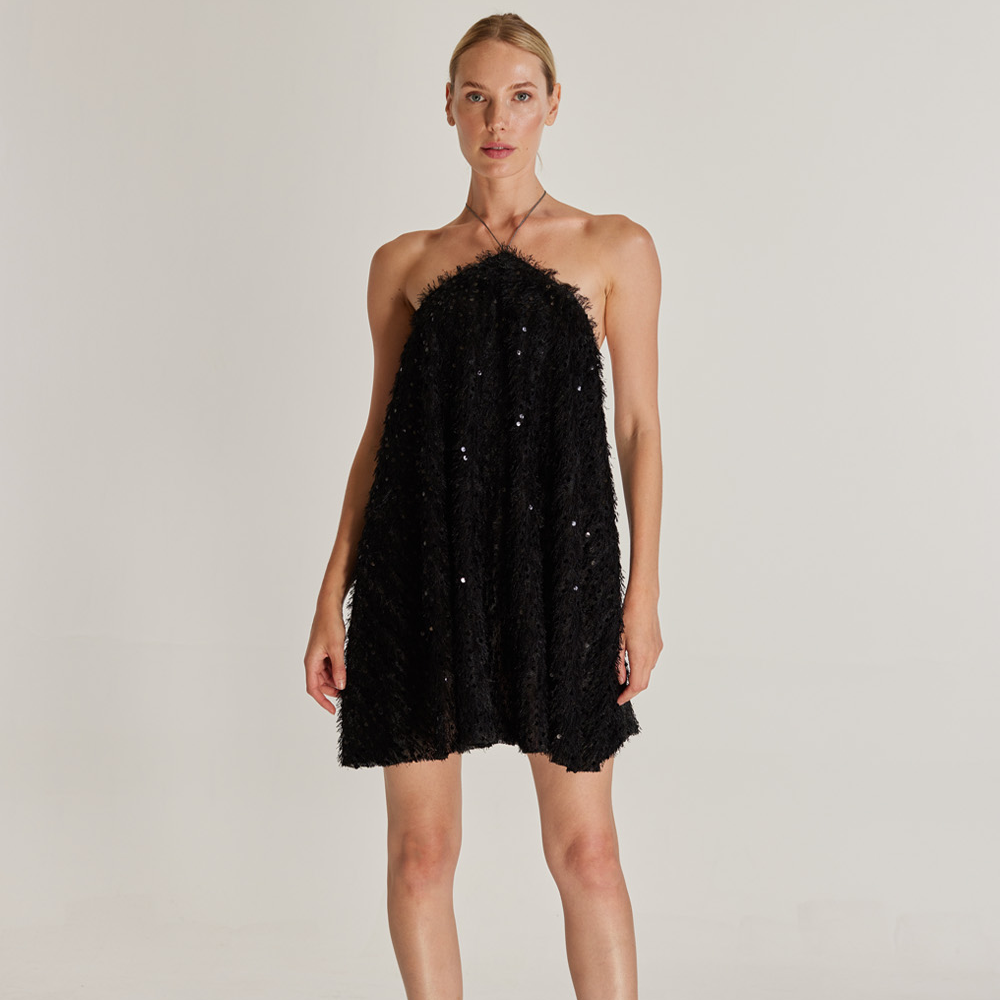 The Sunbeam Dress is a captivating mini dress made from sequined and tasseled black fabric. 