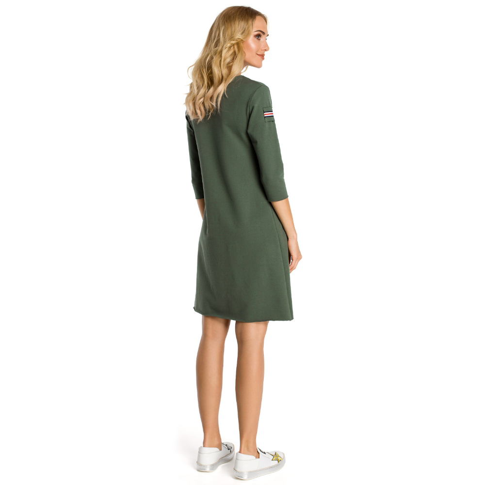 Sweat knit fabric; three-quarter sleeves;&nbsp; trapeze shaped dress; above knee length; front pocket.