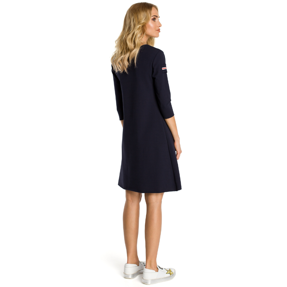 Sweat knit fabric; three-quarter sleeves;&nbsp; trapeze shaped dress; above knee length; front pocket.