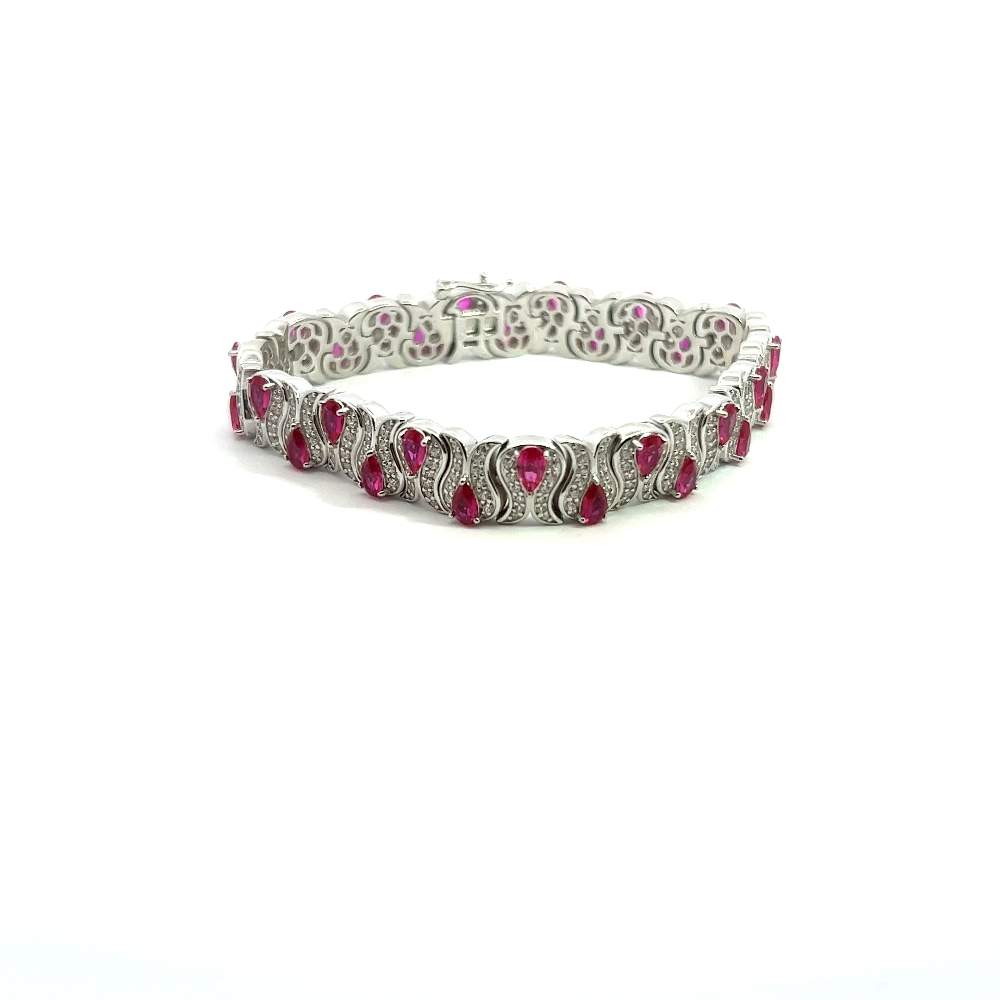 Sterling silver bracelet with lab-created ruby stones and sparkling cubic zirconia for a bold timeless look. Shop premium jewelry online.