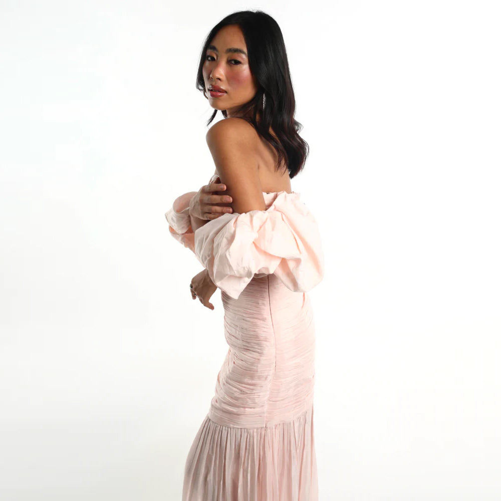 Blush off shoulder dress with puff sleeves and breezy skirt, perfect for parties. Shop online from our curated edit of premium fashion.