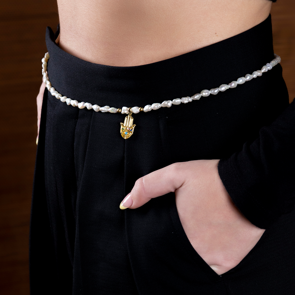 The Athena Pearl Body Chain is combined entirely of precious Keshi Baroque Pearls with 22K Gold Vermeil & a multicolor stones hand charm. Shop now!