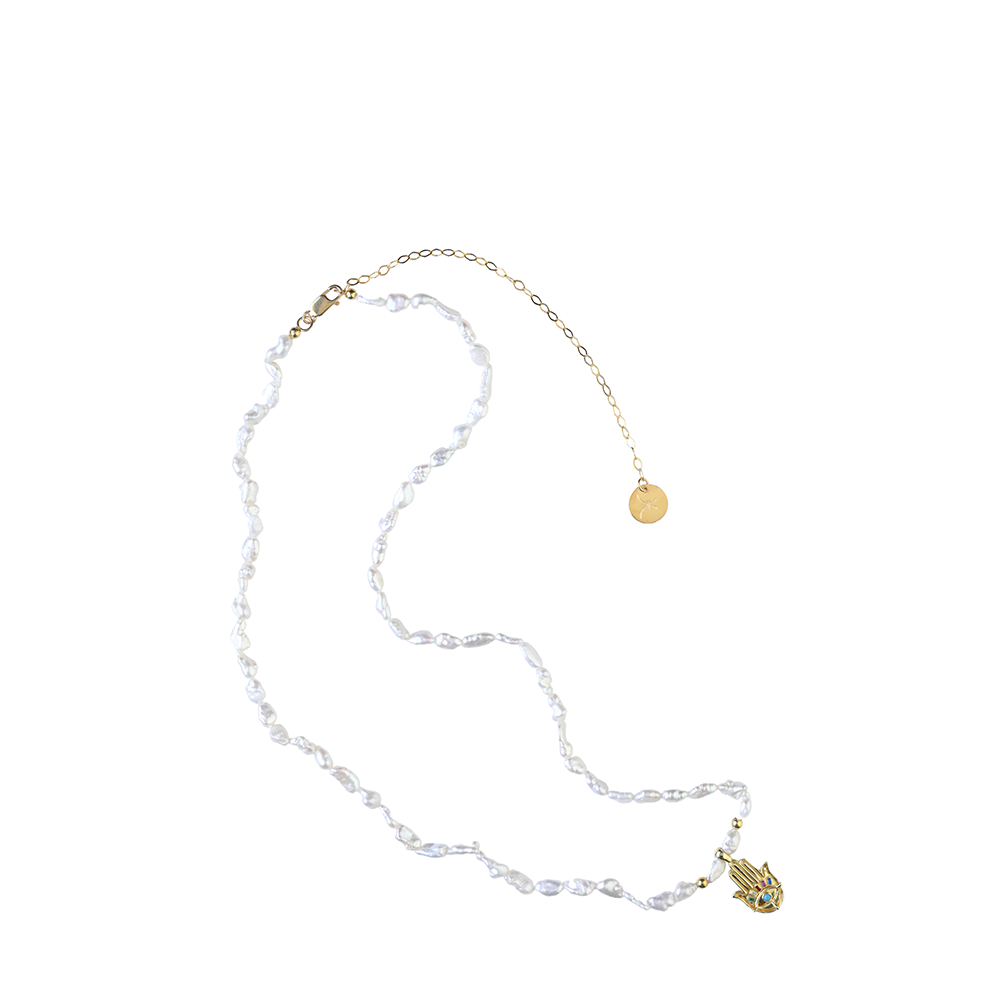 The Athena Pearl Body Chain is combined entirely of precious Keshi Baroque Pearls with 22K Gold Vermeil & a multicolor stones hand charm. Shop now!