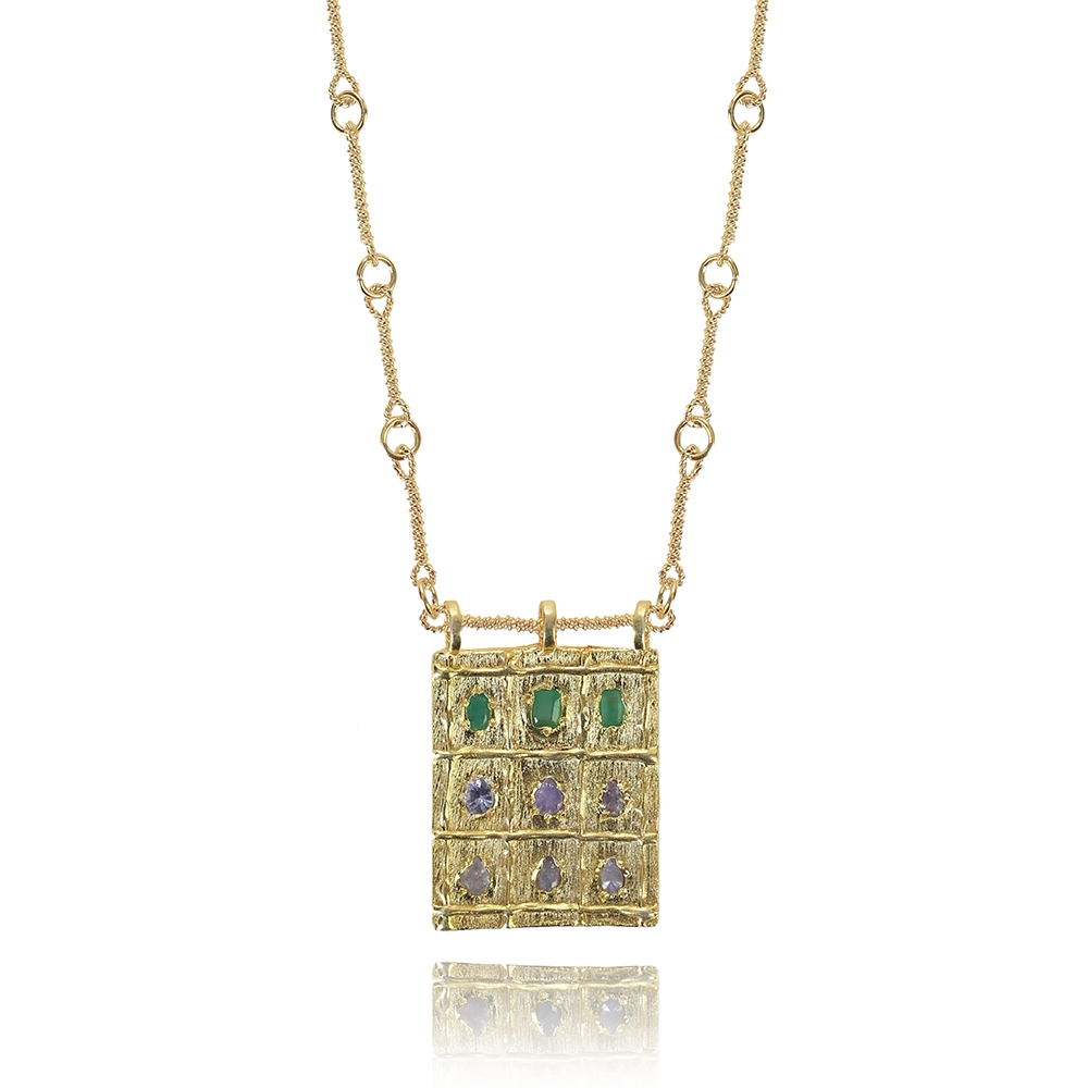 The Atlas Amulet- precious Root Emerald and Tanzanite gemstones hand-sculpted by 22K Gold Vermeil. Shop the exclusive design online here. Shop now! 