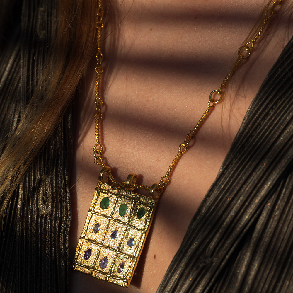 The Atlas Amulet- precious Root Emerald and Tanzanite gemstones hand-sculpted by 22K Gold Vermeil. Shop the exclusive design online here. Shop now! 