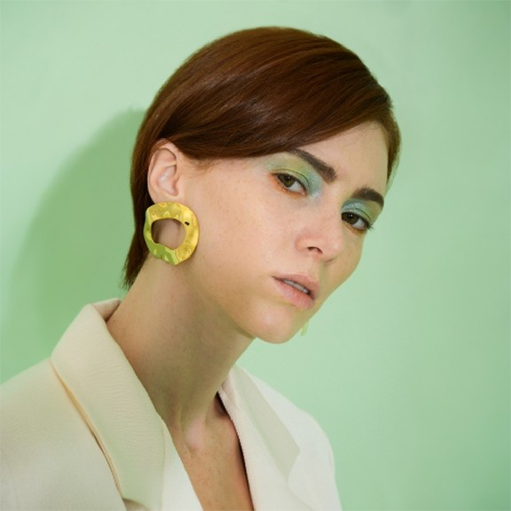 Statement earrings with a reflective surface.