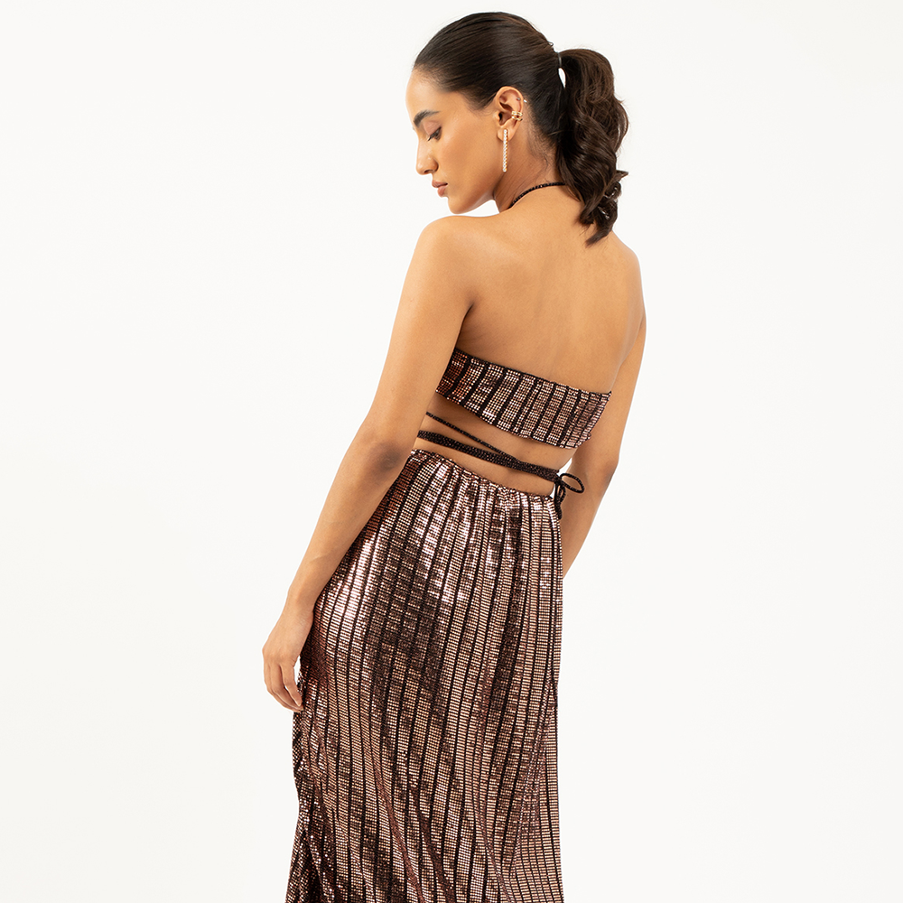 Shop our bronze sequin maxi skirt with a side slit. Explore our stylish curation of designer party outfits to elevate your game. Shop now! 