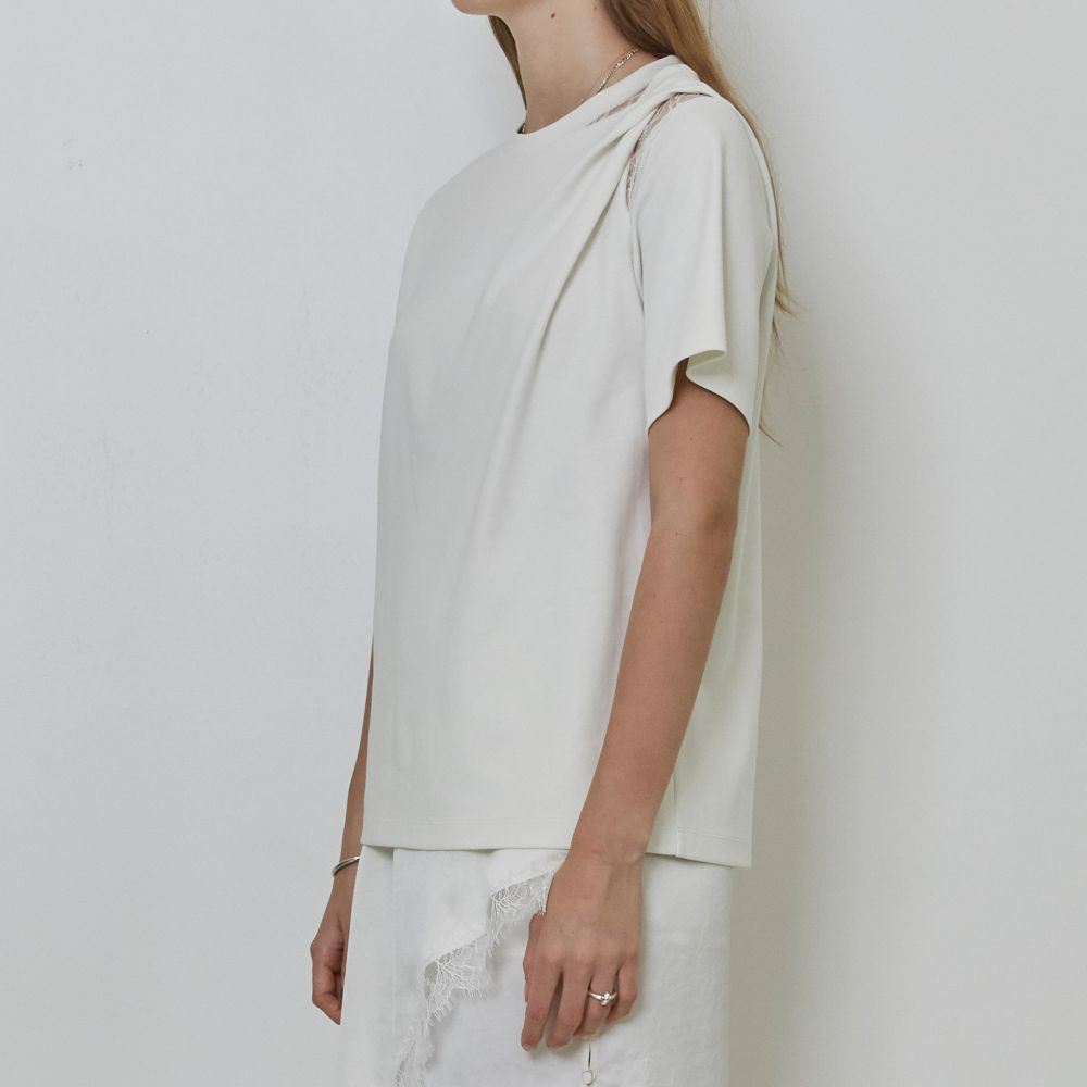 Raw-edged, Round neckline One side handkerchief-hem with patch pocket Adjustable tie belt at waist Relaxed silhouette. 