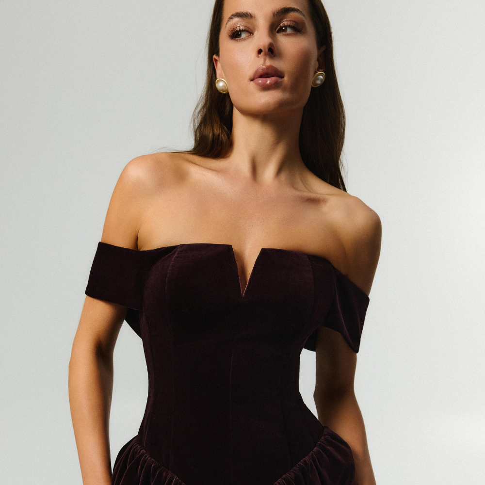 Elegant velvet corset dress with a beautiful neckline and flowing full skirt. Shop now at our exclusive clothing website.