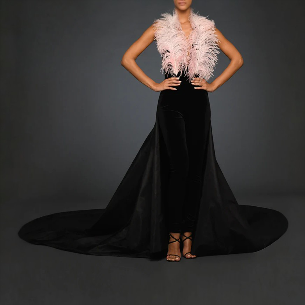 Black velvet jumpsuit with pink ostrich feathers, Black taffeta train.