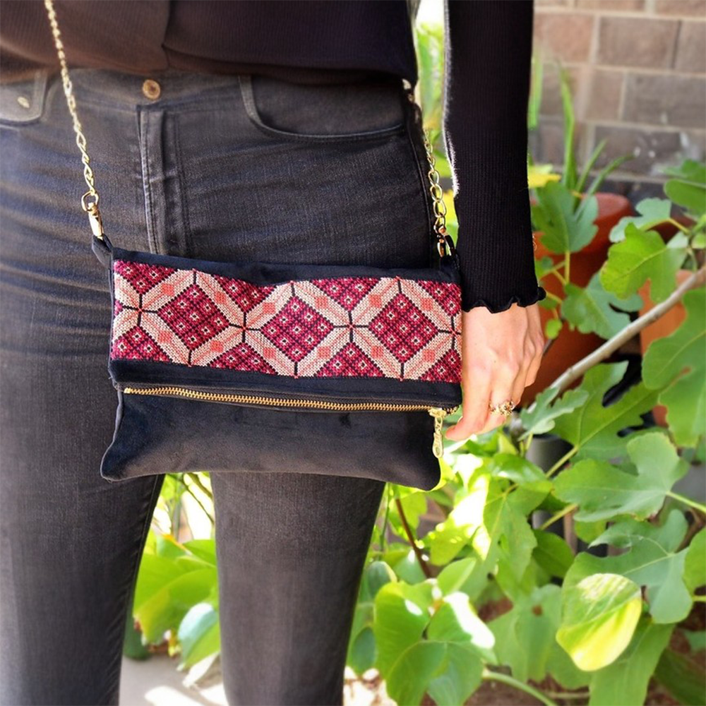 Our tatreez crossbody bag is hand-embroidered with a traditional Palestinian tatreez design.