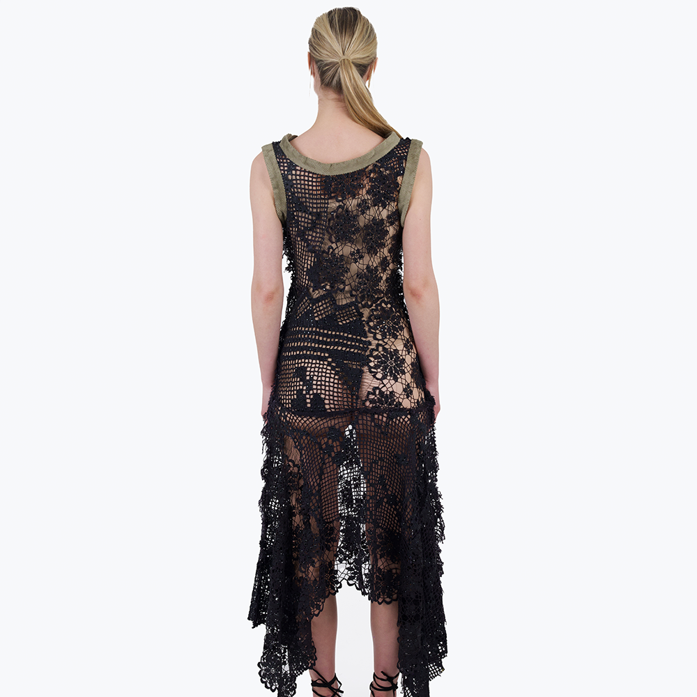 A one-of-a-kind patchwork of vintage lace and crochets, stitched together and embellished with black foil